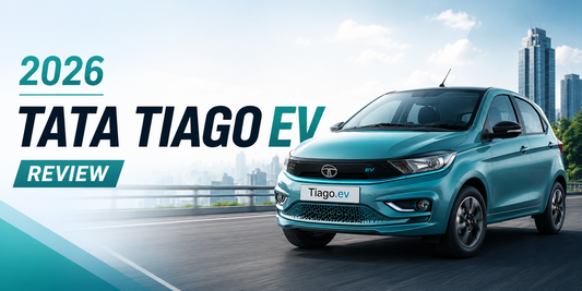 2026 Tata Tiago EV review banner featuring the updated electric hatchback on a city road with modern urban skyline background